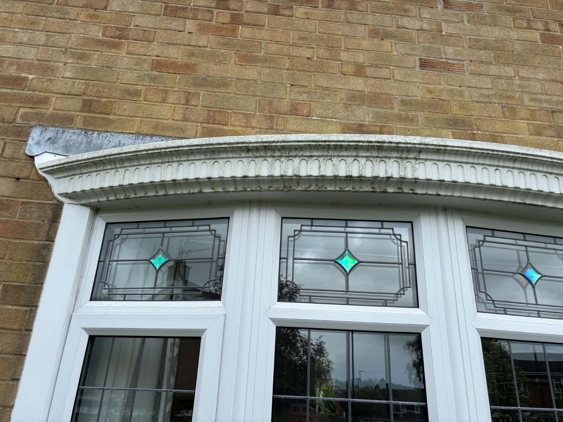 Before — Decorative roofline and bay brought back to white